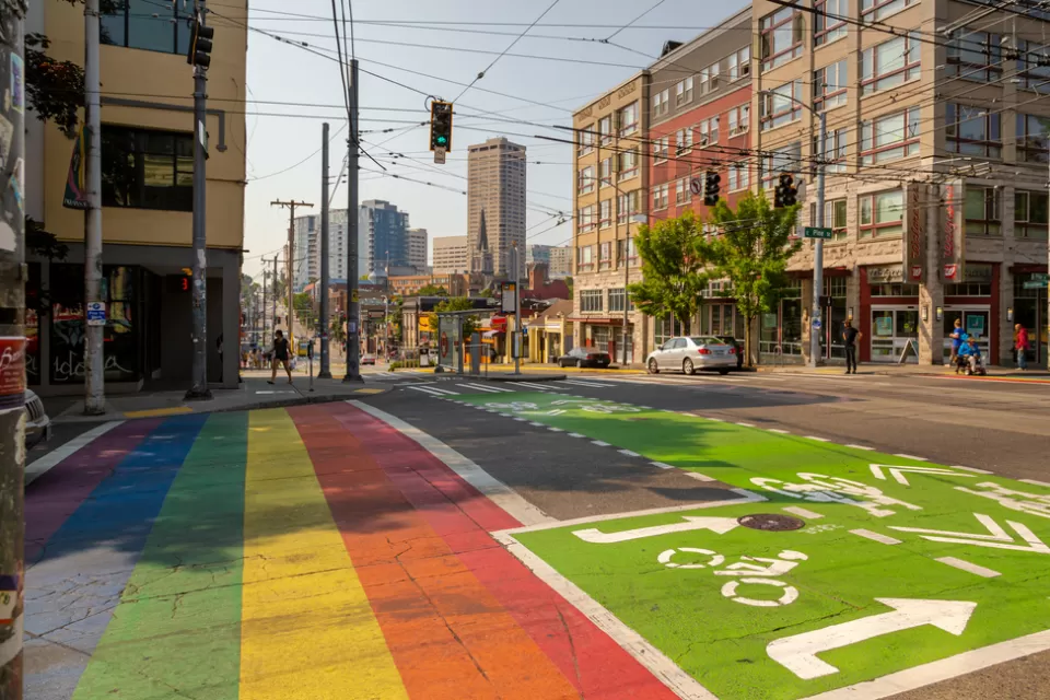 Rainbow painted crosswalk next to green painted bike lane on Seattle, Washington street
